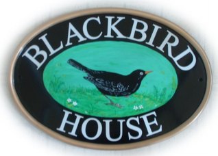 Blackbird - The customer ordered two lNew World classic oval signs for her house. Our artist Jean painted one blackbird facing left and one facing right. font is called Times Roman