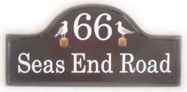 Seagulls - The customer asked for a simple design depicting a seagull either side of the numbner .Painted on a large mews house plaque by Gerry